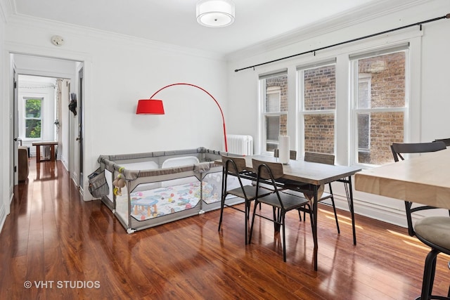 5814 N Campbell Ave, Chicago, IL 60659 - dining area with wood finished floors, crown molding, and radiator