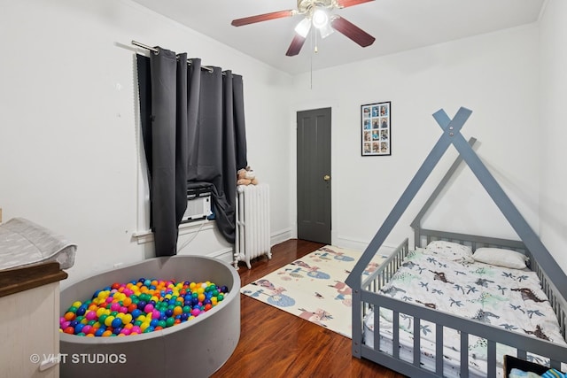 5814 N Campbell Ave, Chicago, IL 60659 - bedroom with radiator heating unit, wood finished floors, and ceiling fan