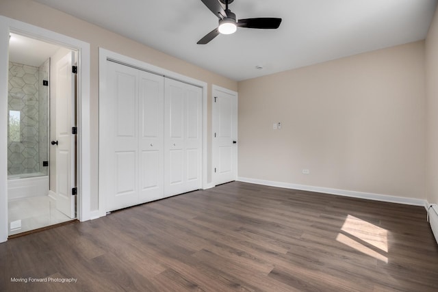 unfurnished bedroom with wood finished floors, baseboards, and a closet