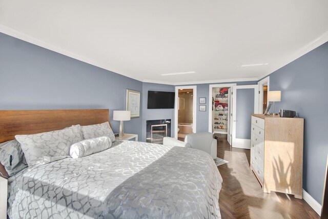 2626 N Lakeview Ave Unit 2703, Chicago, IL 60614 - bedroom with crown molding, baseboards, and a glass covered fireplace