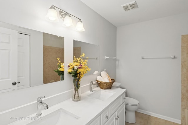667 W Jonathan Dr, Round Lake, IL 60073 - bathroom featuring tile patterned floors, toilet, double vanity, and baseboards