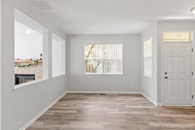 667 W Jonathan Dr, Round Lake, IL 60073 - entrance foyer featuring wood finished floors, baseboards, and a glass covered fireplace