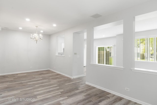 667 W Jonathan Dr, Round Lake, IL 60073 - empty room with a chandelier, recessed lighting, baseboards, and wood finished floors