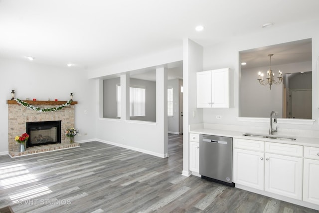667 W Jonathan Dr, Round Lake, IL 60073 - kitchen featuring dishwasher, a sink, light wood finished floors, white cabinets, and light countertops