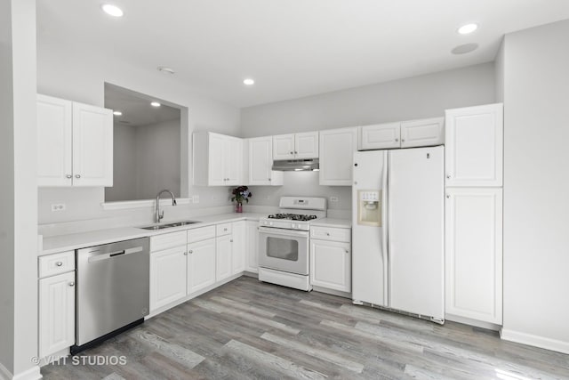667 W Jonathan Dr, Round Lake, IL 60073 - kitchen with white appliances, a sink, under cabinet range hood, white cabinets, and recessed lighting