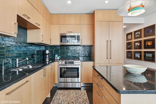 510 W Erie St Unit 1606, Chicago, IL 60654 - kitchen featuring appliances with stainless steel finishes, light brown cabinets, a sink, dark stone counters, and backsplash