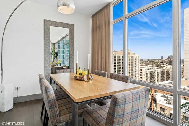 510 W Erie St Unit 1606, Chicago, IL 60654 - dining room featuring a view of city, wood finished floors, and baseboards