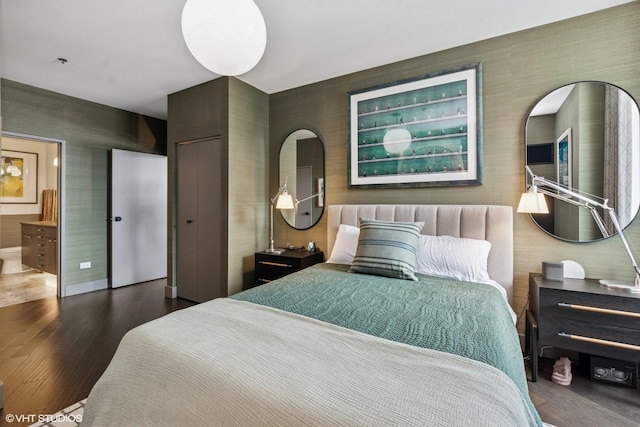 510 W Erie St Unit 1606, Chicago, IL 60654 - bedroom featuring wood finished floors, baseboards, connected bathroom, and wallpapered walls