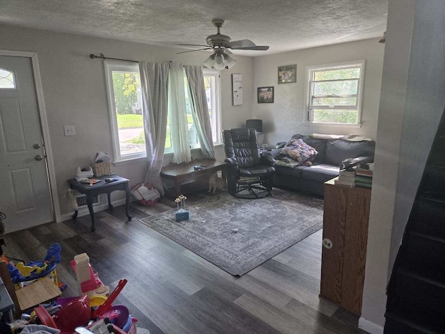 living area with a textured ceiling, wood finished floors, and a ceiling fan