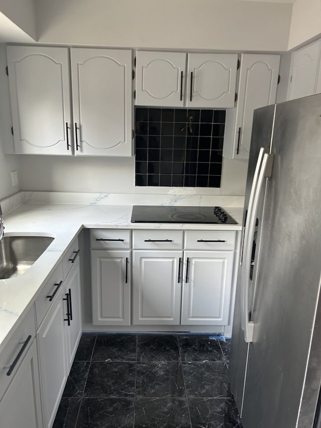 18W118 14th St, Villa Park, IL 60181 - kitchen with freestanding refrigerator, black electric cooktop, white cabinets, dark marble finish flooring, and decorative backsplash