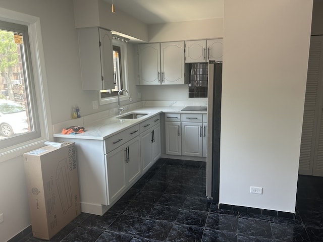 18W118 14th St, Villa Park, IL 60181 - kitchen with dark marble finish flooring, light countertops, white cabinets, and freestanding refrigerator
