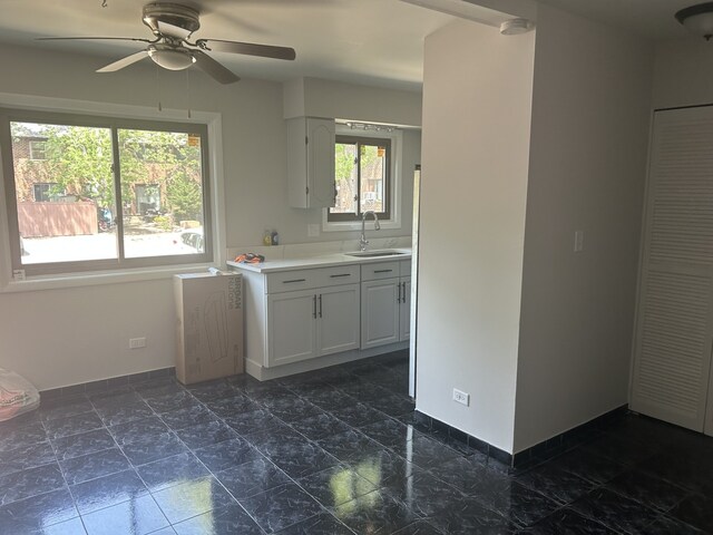 18W118 14th St, Villa Park, IL 60181 - kitchen featuring light countertops, ceiling fan, and white cabinetry
