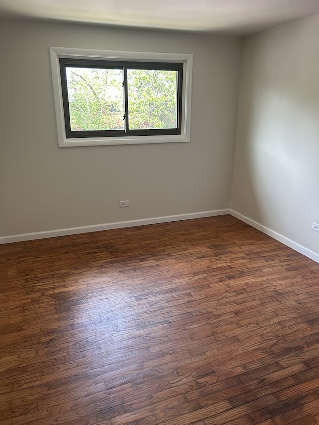 18W118 14th St, Villa Park, IL 60181 - spare room featuring dark wood-style flooring and baseboards