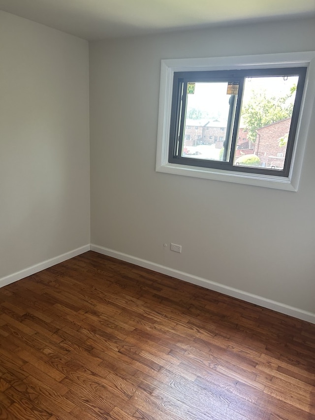 18W118 14th St, Villa Park, IL 60181 - empty room featuring dark wood-style flooring and baseboards