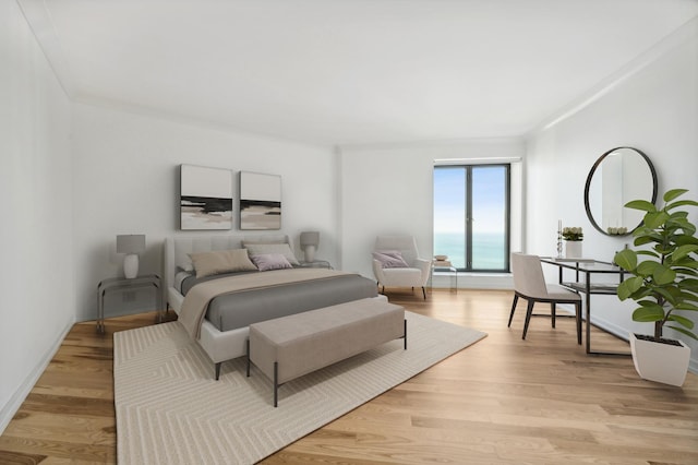 bedroom featuring light wood-type flooring, ornamental molding, and baseboards