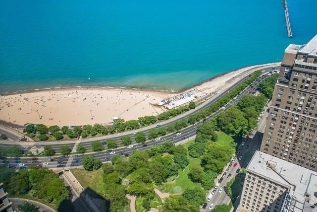 aerial overview of property's location featuring expansive beach and a main thoroughfare