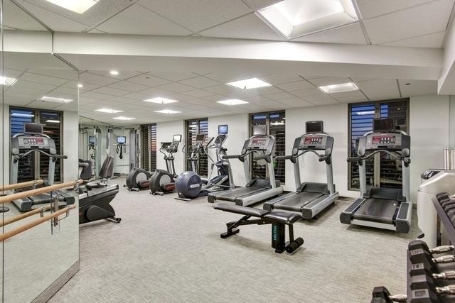 gym featuring carpet and a drop ceiling