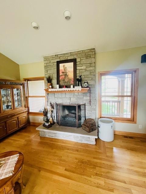 1976 E 24th Rd, Ransom, IL 60470 - living area with baseboards, a stone fireplace, wood finished floors, and lofted ceiling
