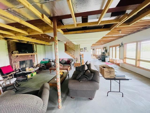 1976 E 24th Rd, Ransom, IL 60470 - living room with a fireplace, stairway, and concrete floors