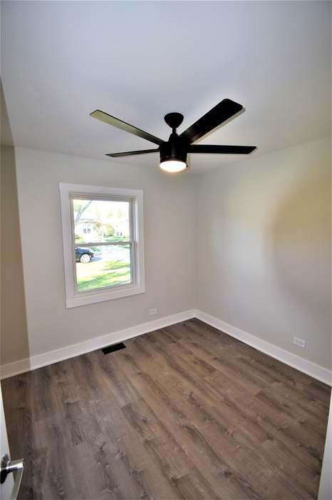 700 Delphia Ave, Elk Grove Village, IL 60007 - unfurnished room featuring dark wood-style floors and baseboards