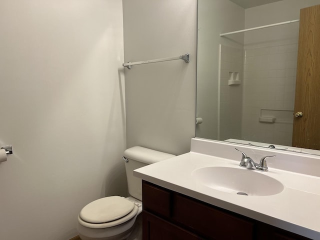 full bath with toilet, vanity, and a shower