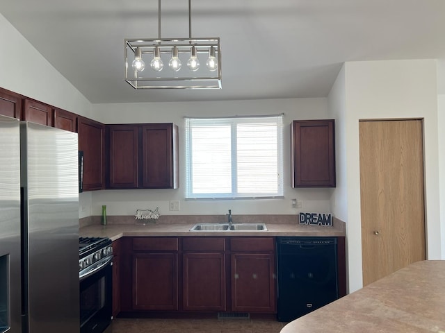 kitchen featuring freestanding refrigerator, black dishwasher, gas range, a sink, and light countertops