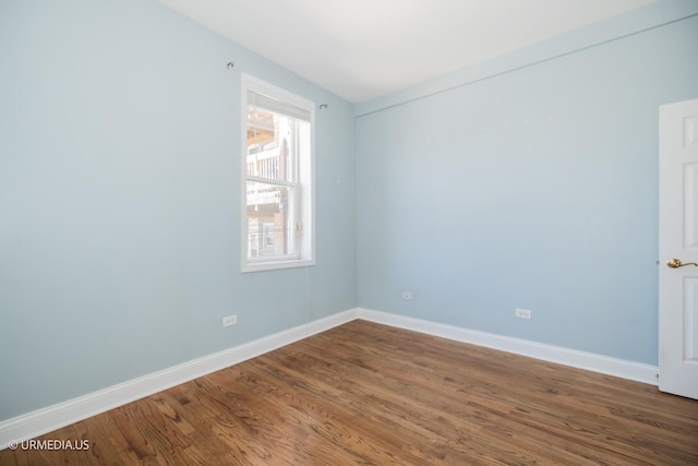 unfurnished room with wood finished floors and baseboards