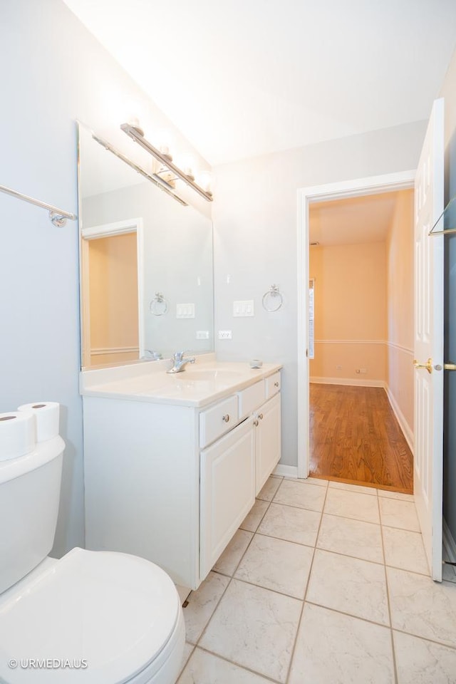 bathroom featuring toilet, vanity, and tile patterned flooring