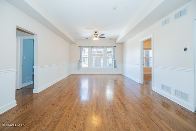 spare room with a ceiling fan and wood finished floors