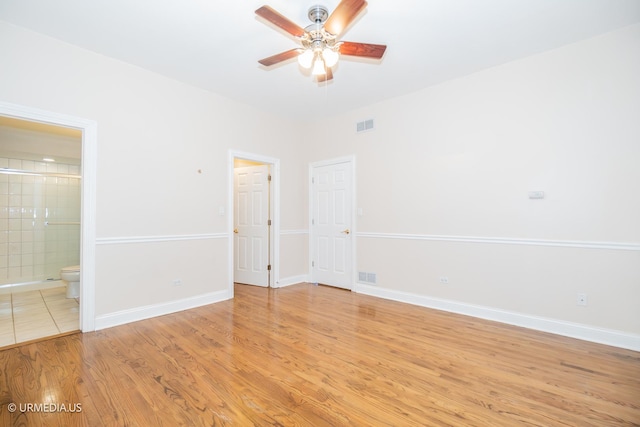 unfurnished room featuring ceiling fan, light wood-style flooring, and baseboards