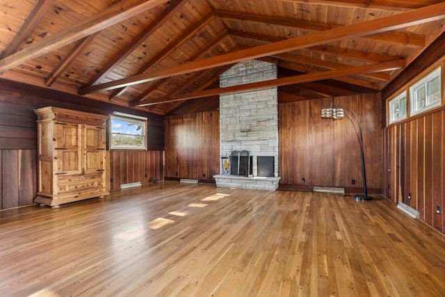 715 Root St, New Lenox, IL 60451 - unfurnished living room with wooden walls, hardwood / wood-style floors, a stone fireplace, and wooden ceiling