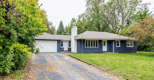 ranch-style house with driveway, a chimney, an attached garage, and a front yard