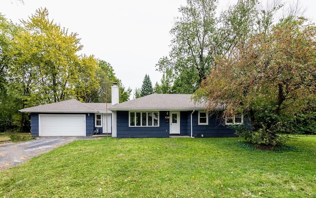 ranch-style house with a chimney, a garage, asphalt driveway, and a front yard