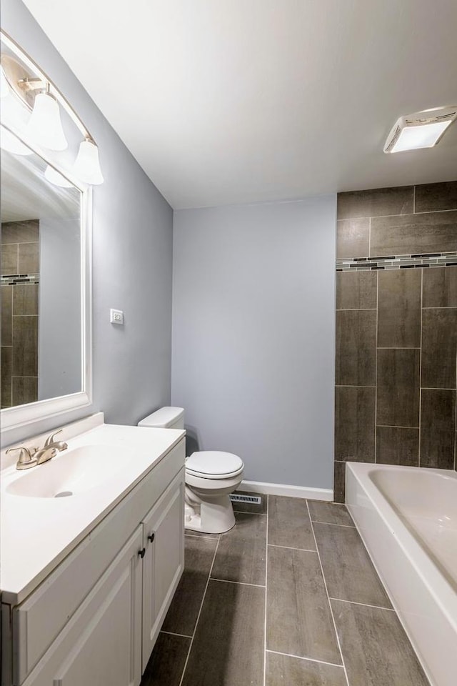 bathroom featuring toilet, vanity, and wood tiled floors