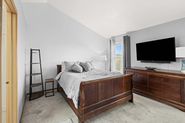 21628 Dogwood Rd Unit 120-3, Matteson, IL 60443 - bedroom featuring light carpet, vaulted ceiling, and baseboards