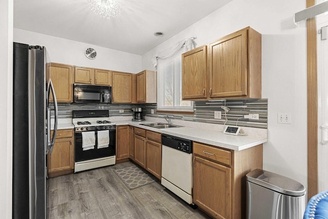 21628 Dogwood Rd Unit 120-3, Matteson, IL 60443 - kitchen with range with gas stovetop, white dishwasher, black microwave, freestanding refrigerator, and a sink