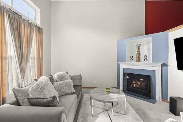 21628 Dogwood Rd Unit 120-3, Matteson, IL 60443 - carpeted living room featuring a high ceiling, a fireplace, and baseboards