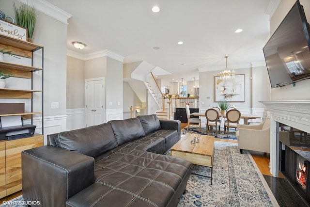 209 S Evergreen Ave, Arlington Heights, IL 60005 - living room with a decorative wall, stairway, a fireplace with flush hearth, a chandelier, and ornamental molding