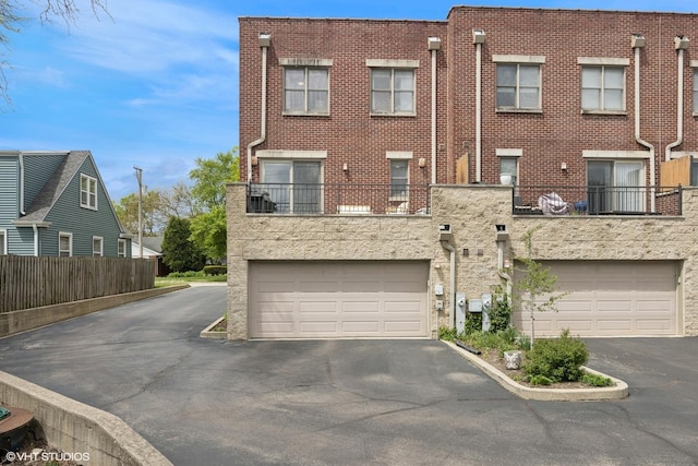 209 S Evergreen Ave, Arlington Heights, IL 60005 - back of property with asphalt driveway, a garage, brick siding, and fence