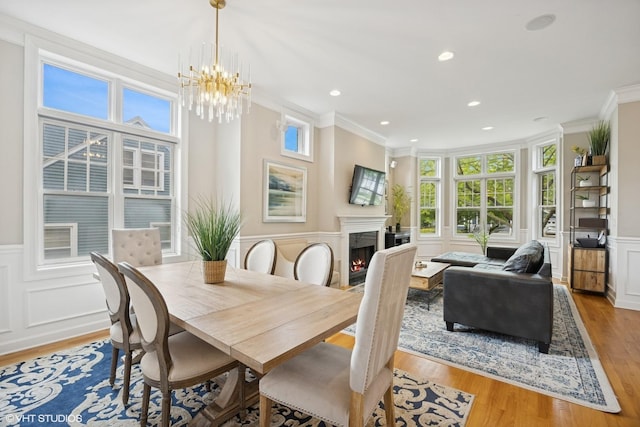 209 S Evergreen Ave, Arlington Heights, IL 60005 - dining space with crown molding, a decorative wall, a high end fireplace, a chandelier, and wood finished floors