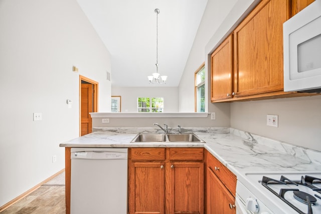 21315 W Edison Ln, Plainfield, IL 60544 - kitchen with white appliances, a sink, a peninsula, vaulted ceiling, and a chandelier