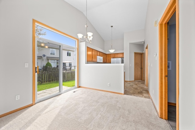 21315 W Edison Ln, Plainfield, IL 60544 - spare room with healthy amount of natural light, lofted ceiling, light carpet, a chandelier, and baseboards