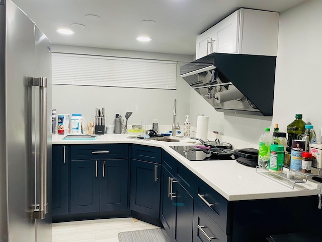 4623 S Harding Ave, Chicago, IL 60632 - kitchen featuring high end fridge, range hood, light countertops, blue cabinets, and recessed lighting