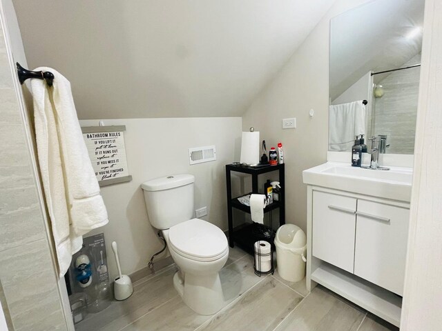4623 S Harding Ave, Chicago, IL 60632 - full bathroom with lofted ceiling, vanity, toilet, and a shower