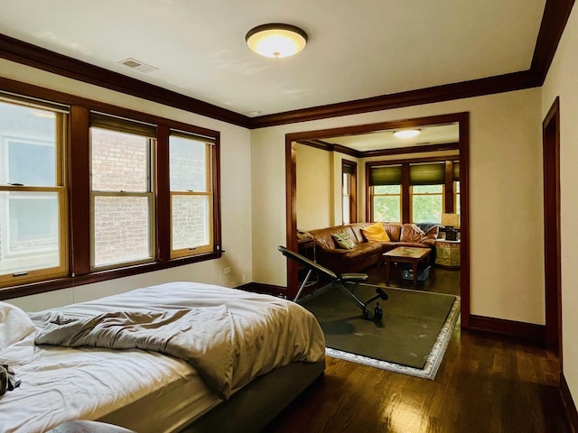 4623 S Harding Ave, Chicago, IL 60632 - bedroom featuring baseboards, dark wood-type flooring, and crown molding