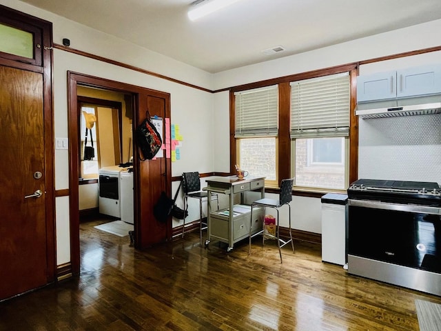 4623 S Harding Ave, Chicago, IL 60632 - kitchen with stainless steel gas range, dark wood-style flooring, under cabinet range hood, independent washer and dryer, and baseboards