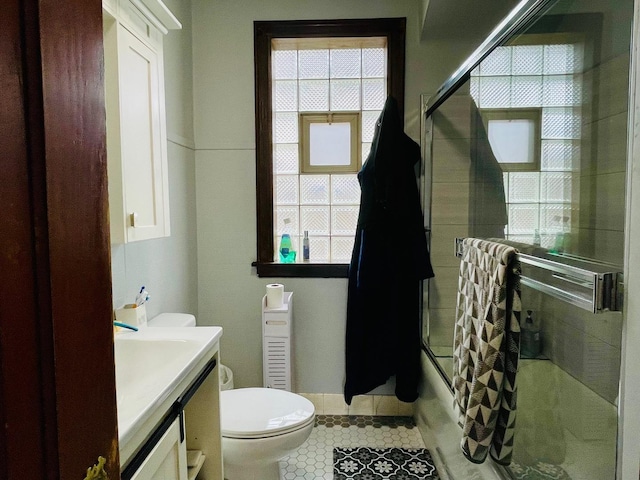 4623 S Harding Ave, Chicago, IL 60632 - bathroom with tile patterned floors, healthy amount of natural light, vanity, and toilet