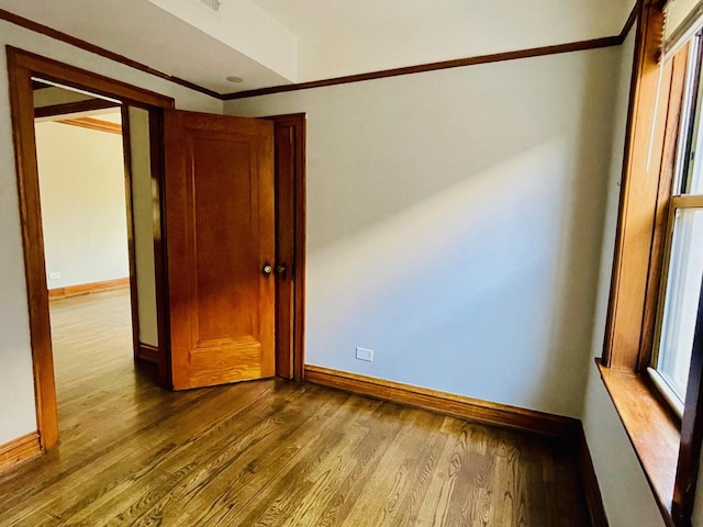 4623 S Harding Ave, Chicago, IL 60632 - unfurnished bedroom with baseboards, wood finished floors, and crown molding