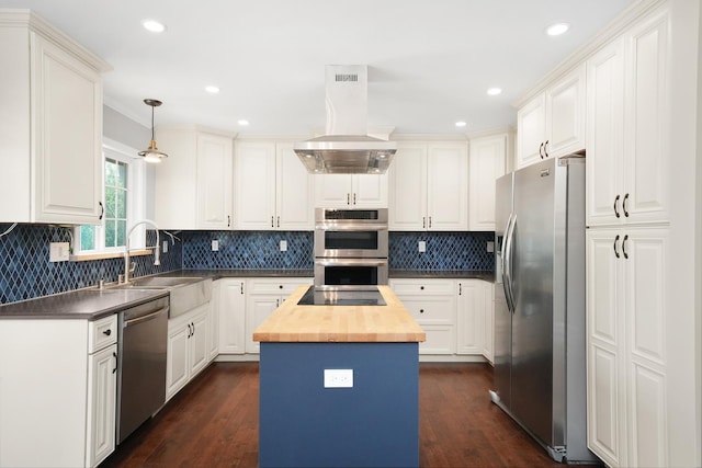 kitchen featuring appliances with stainless steel finishes, wooden counters, a sink, island exhaust hood, and a kitchen island