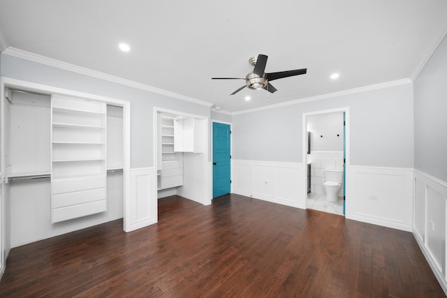 unfurnished bedroom featuring dark wood finished floors, wainscoting, crown molding, recessed lighting, and a ceiling fan